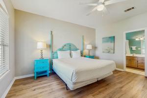 a bedroom with a bed and a ceiling fan at Emerald Shores in Destin +23 photos
