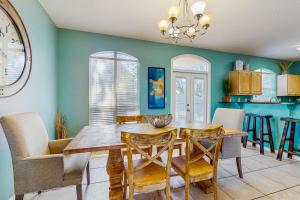 a dining room with a wooden table and chairs at Emerald Shores in Destin