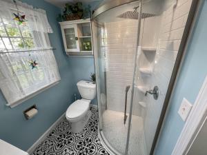 a bathroom with a toilet and a shower at Seaside Cottages - Cottage 37 - Sundancer in South Yarmouth +33 photos