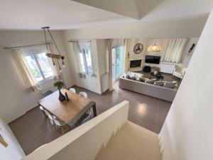 a living room with a table and a couch at Amare Luxury Living in Volos