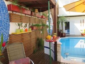 a patio with a swimming pool next to a house at Pousada Cana Caiana in Paraty