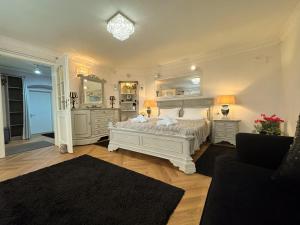 a bedroom with a large white bed and mirrors at Hidden Hollow - Ultra Central in Braşov +13 photos