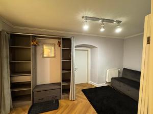 a room with a bed and a closet with shelves at Hidden Hollow - Ultra Central in Braşov