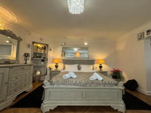 a bedroom with a large bed with two pillows at Hidden Hollow - Ultra Central in Braşov