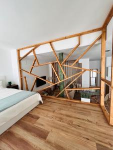 a bedroom with a bed and a wooden floor at Aires de Valencia - Spacious 2-Bedroom Apartment in Valencia