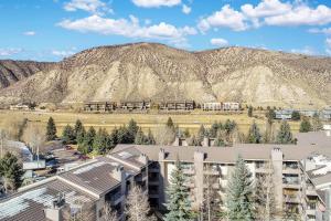 an apartment building with a mountain in the background at Beaver Creek West 26 in Avon
