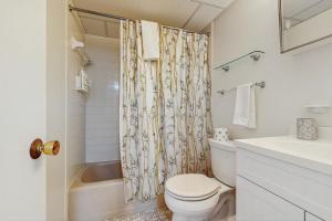 a bathroom with a toilet and a shower curtain at Colonial Unit #502 in Ocean City +12 photos