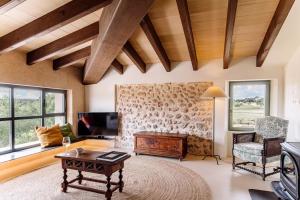 a living room with a table and a tv at Son Seriol in Inca