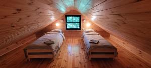 a room with four beds in a log cabin at Nurmenuku suvemaja in Tallinn