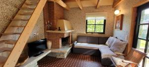 a living room with a couch and a fireplace at Nurmenuku suvemaja in Tallinn