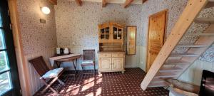 a room with a staircase and a table and a kitchen at Nurmenuku suvemaja in Tallinn