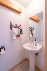 un baño con lavabo y espejo en RR-Hideaway_Down_Cyn 104, en June Lake 14 fotos más