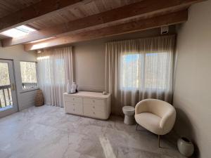 a room with a chair and a dresser and a window at Casa Del Rio in Margaretville +27 photos