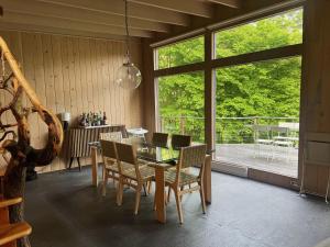 a dining room with a glass table and chairs at Casa Del Rio in Margaretville