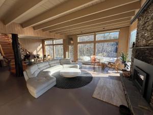 a living room with a white couch and a table at Casa Del Rio in Margaretville