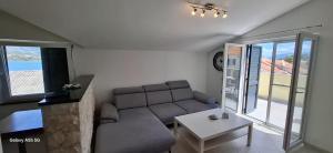 a living room with a couch and a table at Apartmani Brnada in Trogir