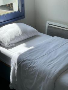 Voodi või voodid majutusasutuse Hôtel Gex toas