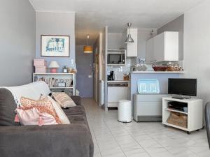 Una sala de estar con un sofá y una cocina. en Studio au pied de la plage, vue mer Les Sables - 4 personnes, en Les Sables-dʼOlonne 4 fotos más