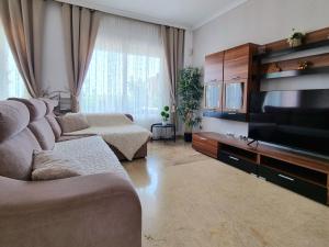 A television and/or entertainment centre at Charming Apartment with a Cozy Terrace