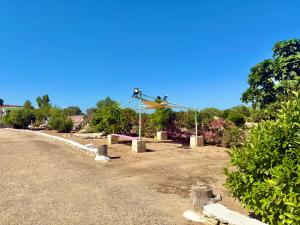 a dirt road with a sign on the side of the road at Villa Giardino Feng Shui in Manduria