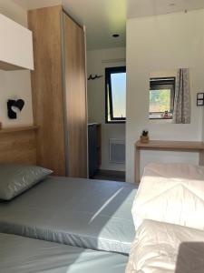 a bedroom with a large bed and two windows at Camp'hôtel Domaine du perche Bellêmois in Bellême