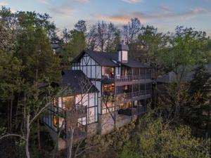 an aerial view of a large house at 5BR Lakefront Sleeps 22 | Deck, Dock & Hot Tub! in Damsel