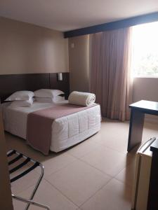 Postel nebo postele na pokoji v ubytování Hotel Dunamys Curitiba