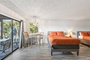 a bedroom with a bed and a table with chairs at 5BR Lakefront Sleeps 22 | Deck, Dock & Hot Tub! in Damsel +66 photos