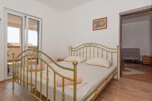 a bedroom with a bed and a glass door at Andrijas Apartments in Tribunj