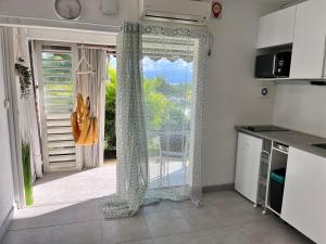 a kitchen with a window with a view of a balcony at O Ti Pozé in Pointe-à-Pitre