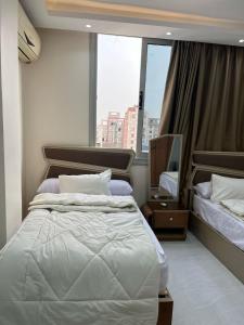 a bedroom with a large bed and a large window at استديو شارع منتصر امام مستشفي الجهاز الهضمي المنصوره والجامعه in Mansoura
