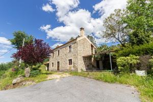 an old stone house on the side of a road at Guest H4U - Nature & Pool Guarda in Seixo Amarelo