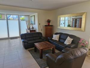 a living room with two couches and a coffee table at STRANDROSE - 300m zum Strand - Kamin - Sauna in Zingst