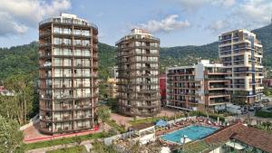 two tall buildings in a city with a pool at Gonio Horizon Apartment in Gonio
