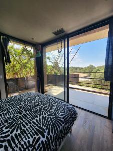 a bedroom with a black and white bed and a large window at Charming villa in the heart of the Mediterranean Garrigue in Nîmes +38 photos