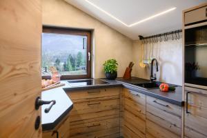 a kitchen with a sink and a window at Bergleben in Krün