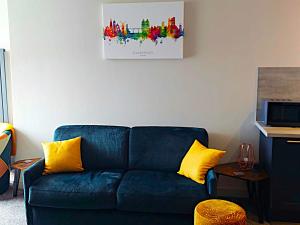 a blue couch with yellow pillows in a living room at 5 Prospect Place - 2nd floor Dream View in Scarborough