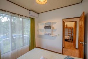 a room with a bed and a mirror and a window at Casa Ceiba in San Francisco +41 photos