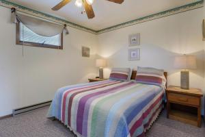 a bedroom with a bed and two lamps and a window at Assateague Inn 109-S in Deep Hole +13 photos