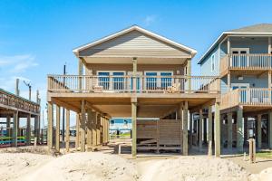 a beach house on the sand with aominiumominium at Direct Beach Access Beachfront in Freeport +29 photos