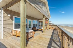a house with a deck with a view of the beach at Direct Beach Access Beachfront in Freeport