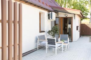 a group of chairs sitting on a patio at Kudirkos namai in Šilutė