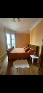 a bedroom with a bed and a window and a rug at Appartement avec Terrasse 14 ème in Paris