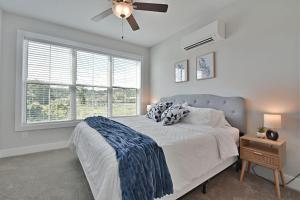 a bedroom with a bed with a ceiling fan and a window at Island Home Retreat in Knoxville