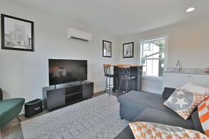 a living room with a couch and a flat screen tv at Island Home Retreat in Knoxville