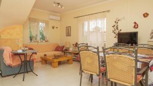 a living room with a couch and a table at Evelyn's House in Artemida