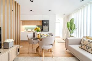 a kitchen and living room with a table and chairs at Seventy Four House in Braga