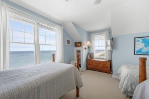 a bedroom with two beds and a large window at 69 Salt Marsh Road East Sandwich - Cape Cod in East Sandwich