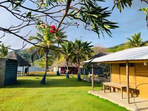 a park with a picnic table and a pavilion at HOSTAL CRUZ DEL MAR in Capurganá