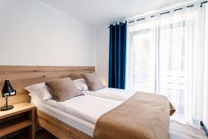 Postel nebo postele na pokoji v ubytování Apartamenty Pod Wyciągiem